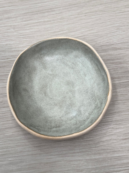 Gray ceramic plate on a wooden surface
